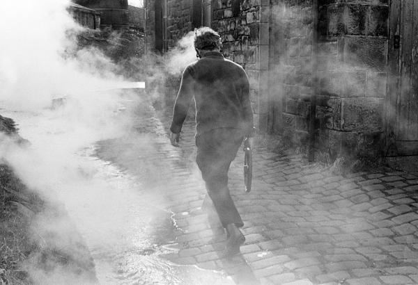 Stanley Graham, mill engineer, ‘blowing down’ (emptying) the Lancashire boiler ready for fluing. April 1977