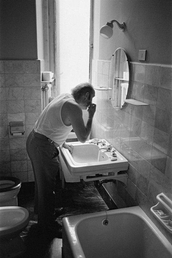 Julian Bream in a hotel bathroom while on tour, Italy. March 1981