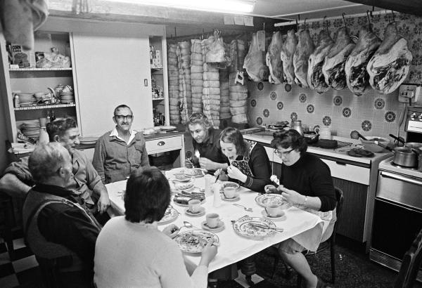 Farmhouse kitchen, lunch break on killing day. Cyril Richardson (arm over back of chair) and family. Old Farm, Little Stainton, near Skipton, North Yorkshire. December 1976