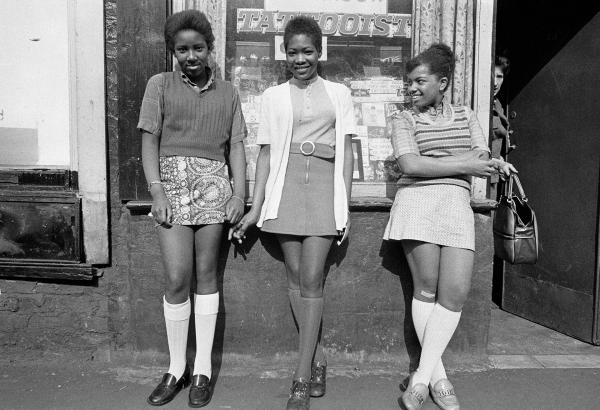 Left Joanne McKenzie, middle Donna Duncan. Teenagers outside the tattoo parlour at no.79C Greame Street, adjacent to The Shop on Greame Street, Moss Side, Manchester. 1972