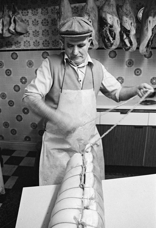 Cyril Richardson knotting twine on a roll of bacon. North Yorkshire 1976