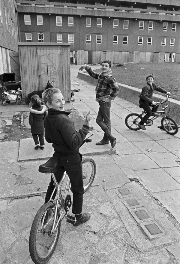 Life goes on while demolition takes place, Bessemer Park, Spennymoor, Co. Durham. February 1983