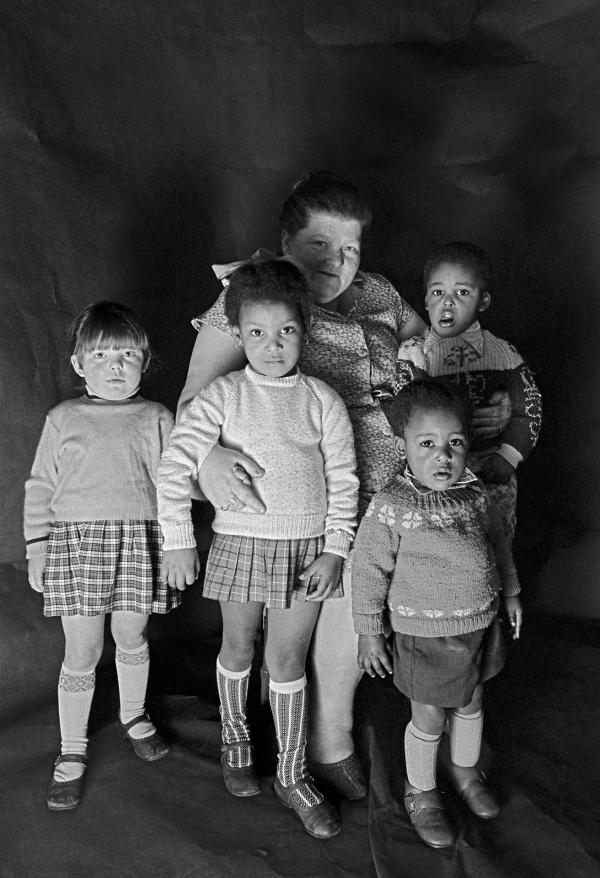 Foster mother with children. Group portrait from The Shop on Greame Street, Moss Side, Manchester. February-April 1972